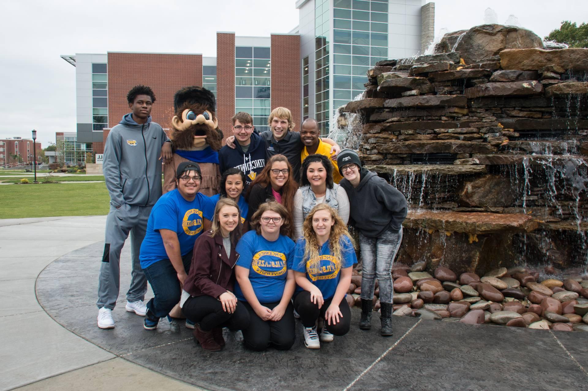 A group of student posing for a photo at Updike Fountain